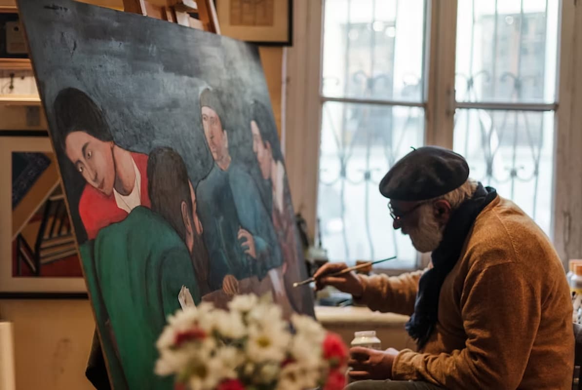 Artista pinta obra clássica em ateliê, representando a diferença entre colecionismo e investimento no mercado de arte. 