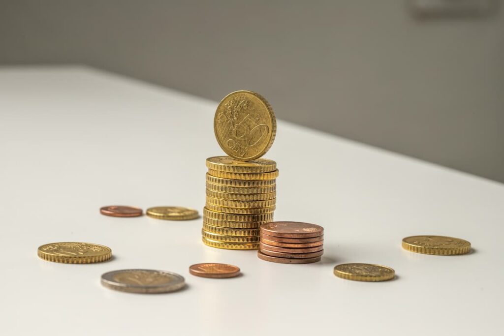Moedas empilhadas em uma mesa representando investimento coletivo e finanças no modelo de crowdfunding.